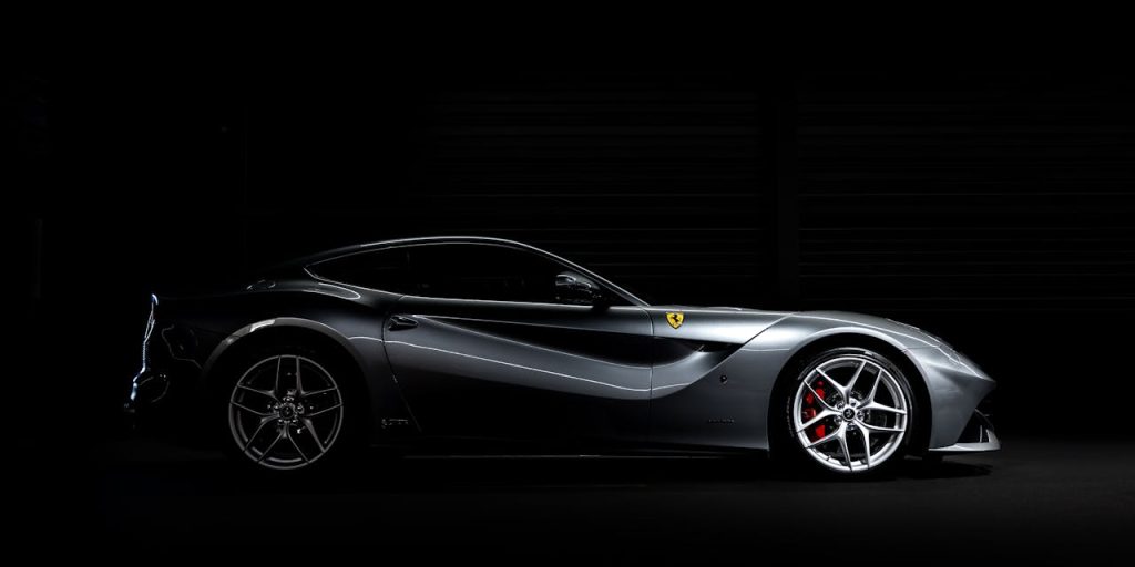 sleek-profile-of-a-luxury-sports-car-in-studio-lighting-33345481 Side profile of a luxury sports car against a dark background, showcasing sleek design.